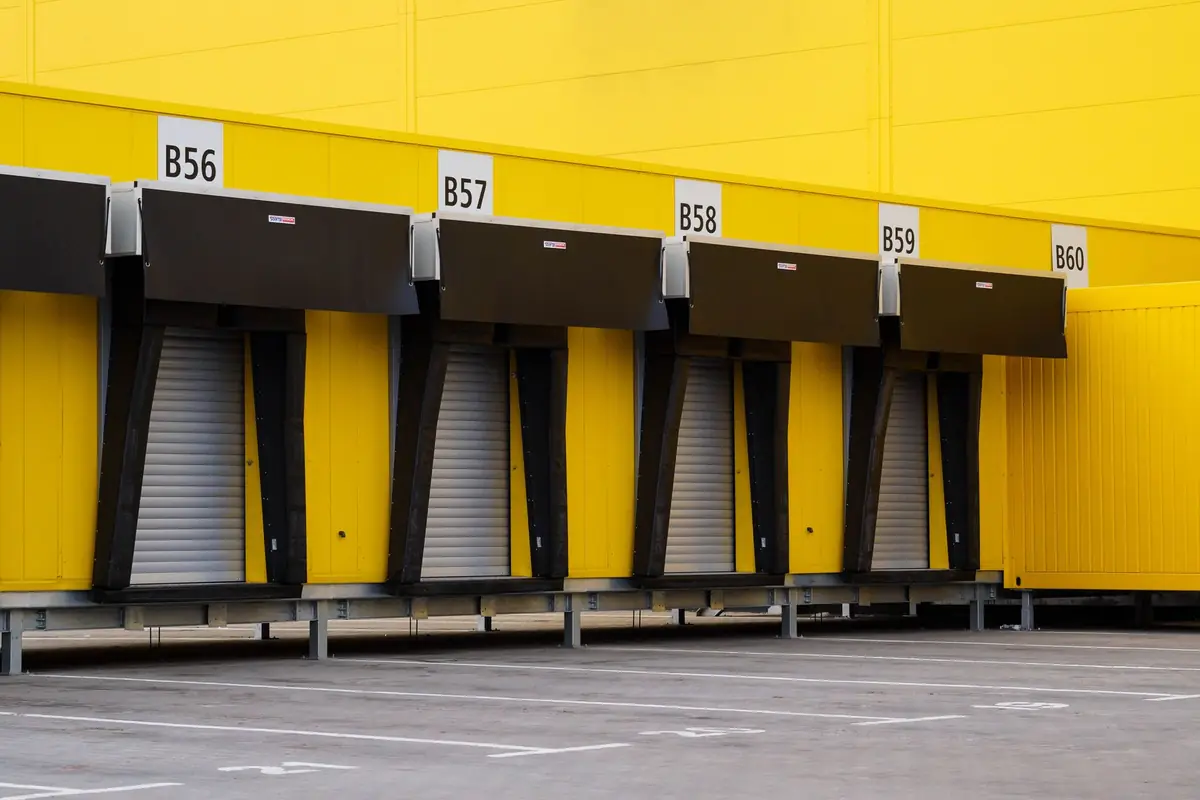 Numbered loading bays on a yellow distribution building