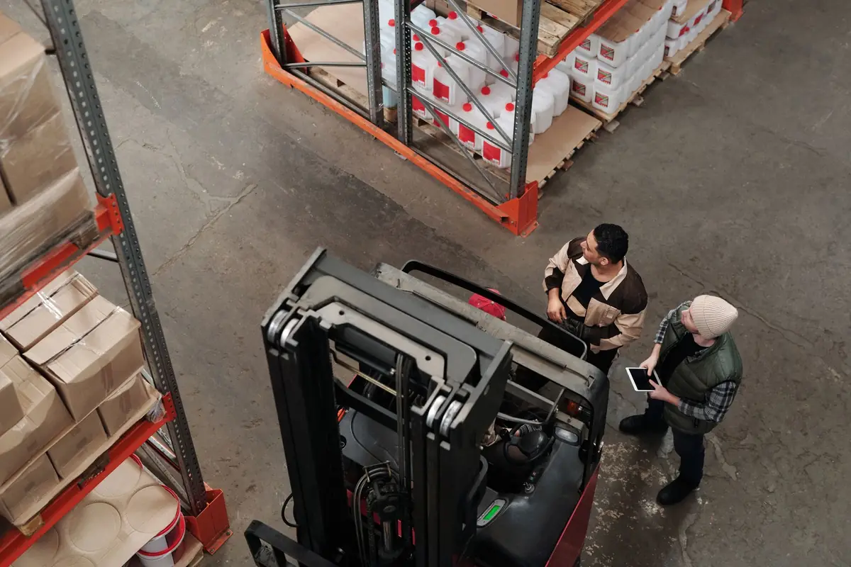 Two workers in high-visibility clothing inside a warehouse